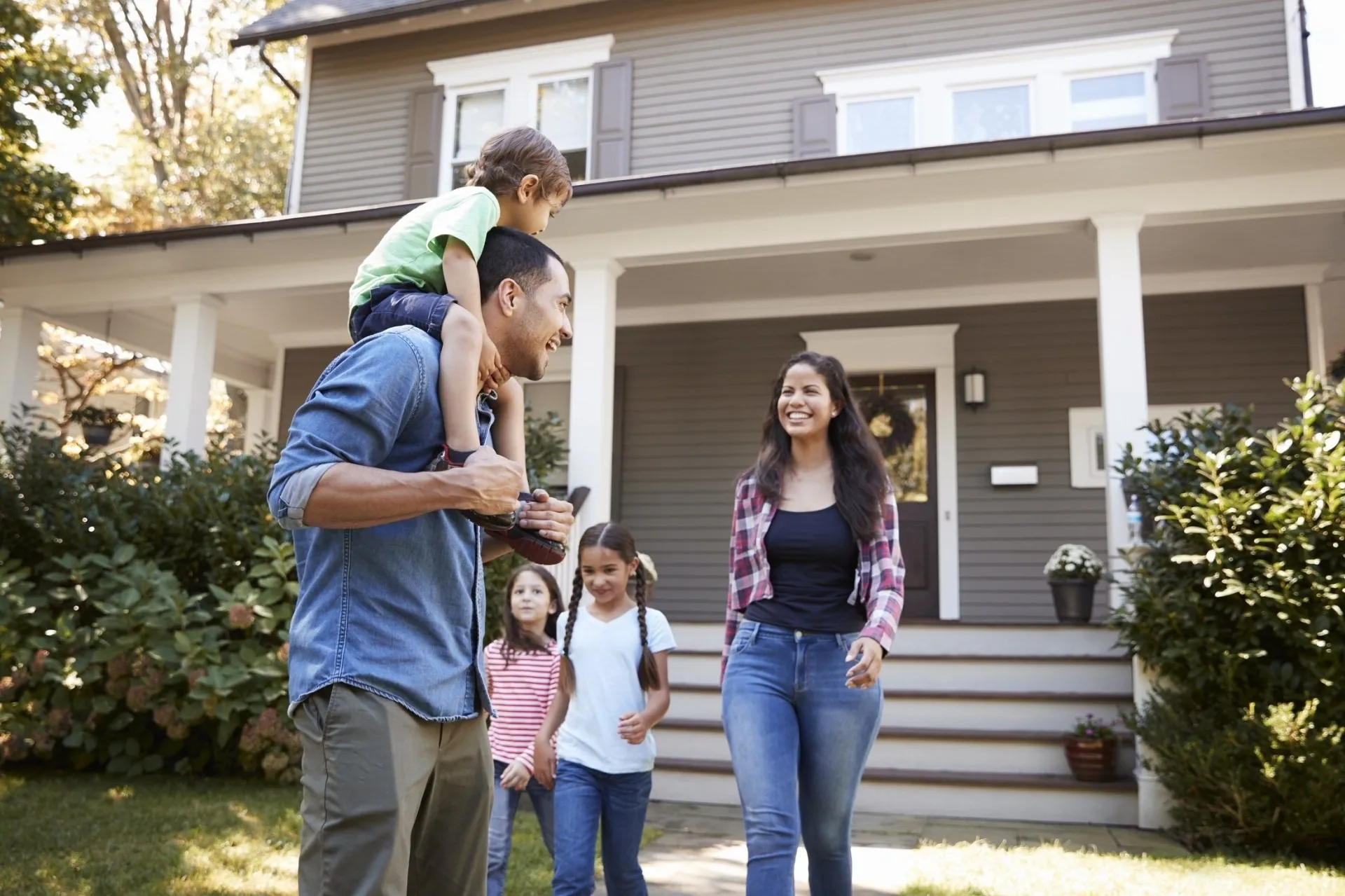 Family In Front of Home