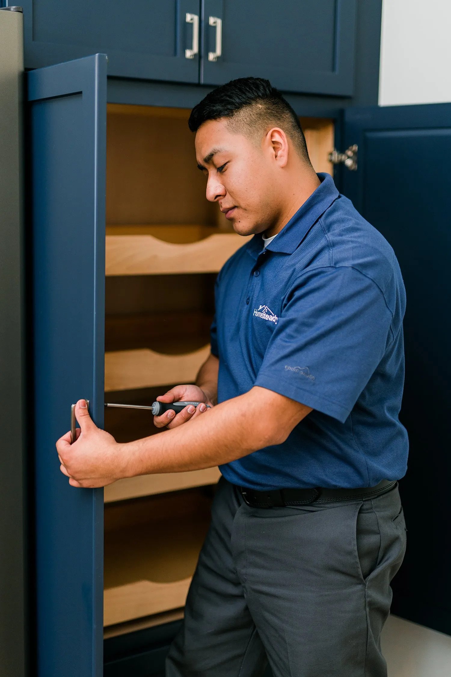 Handyman installs cabinet doors