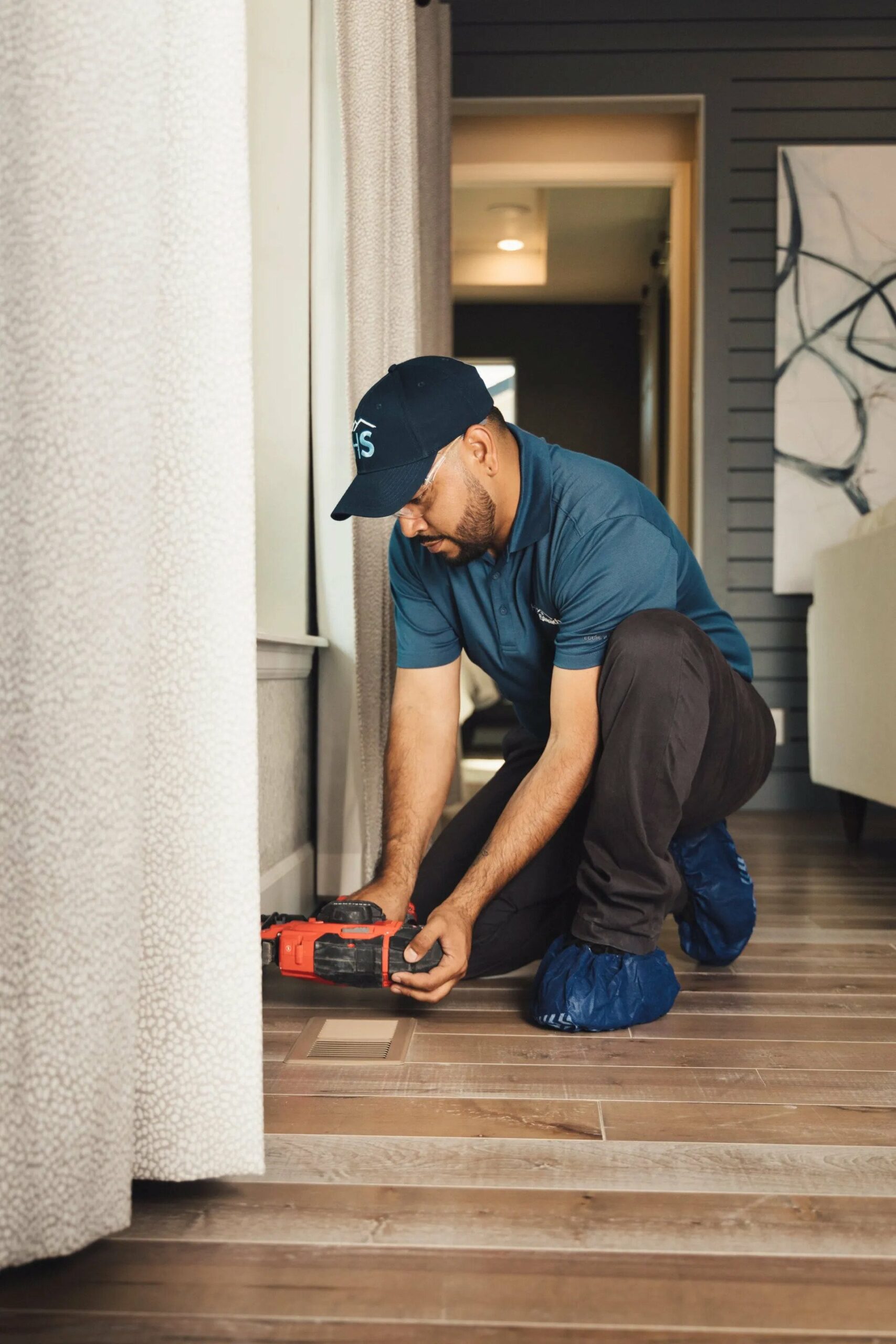 Handyman installs baseboards