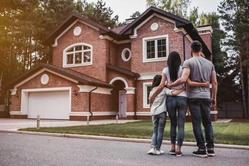 Family Admires Front of Their Home