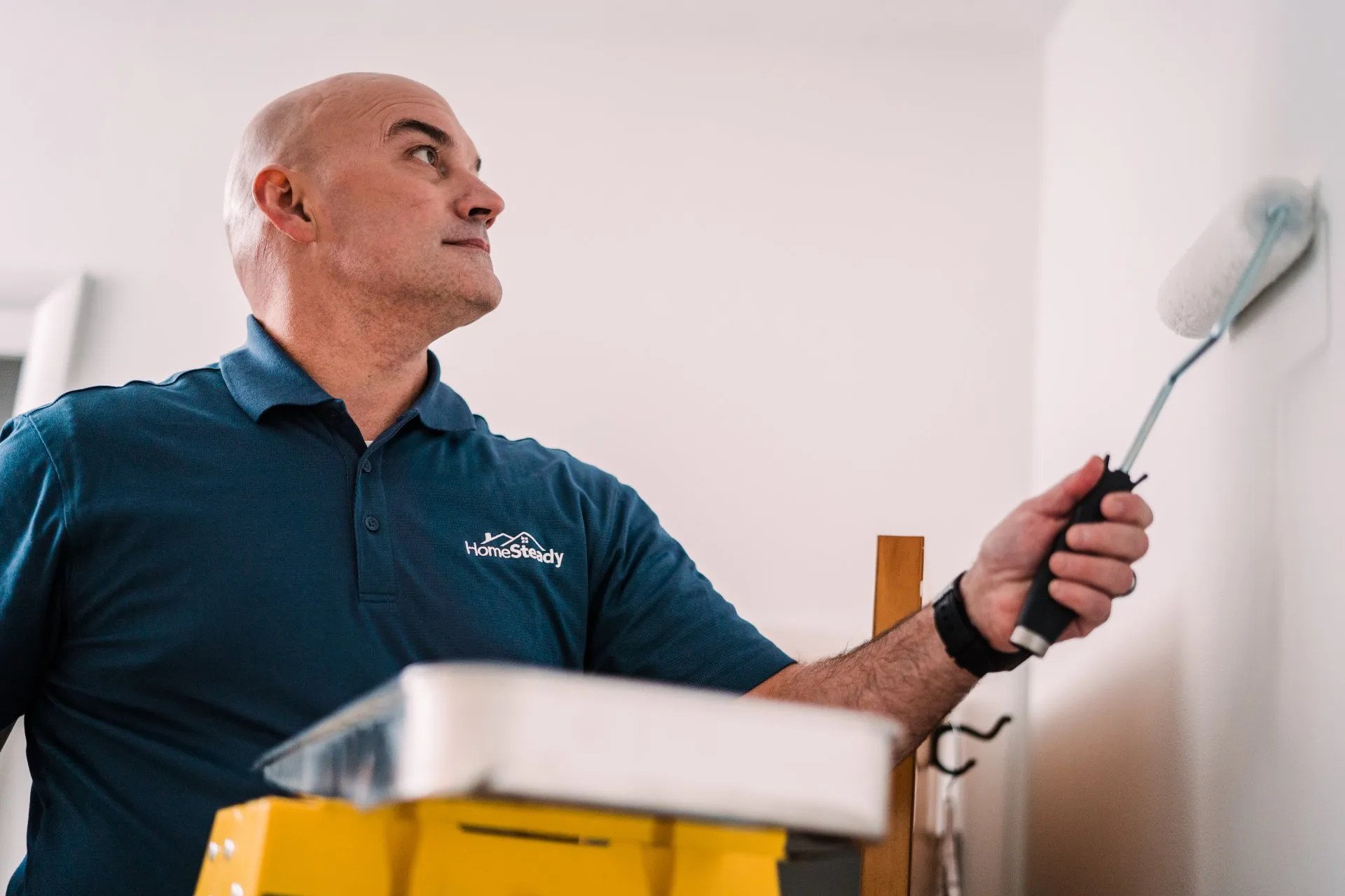 Handyman Paints a Wall